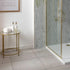 Bathroom interior with a shower area and a small round table with toiletries.