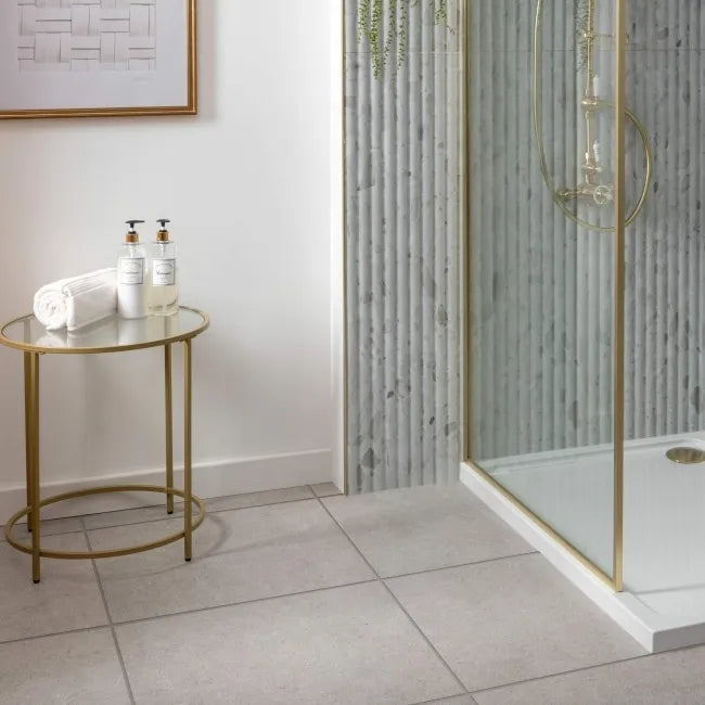 Bathroom interior with a shower area and a small round table with toiletries.