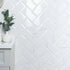 White tiled wall with a marble subway geometric pattern in a bathroom setting