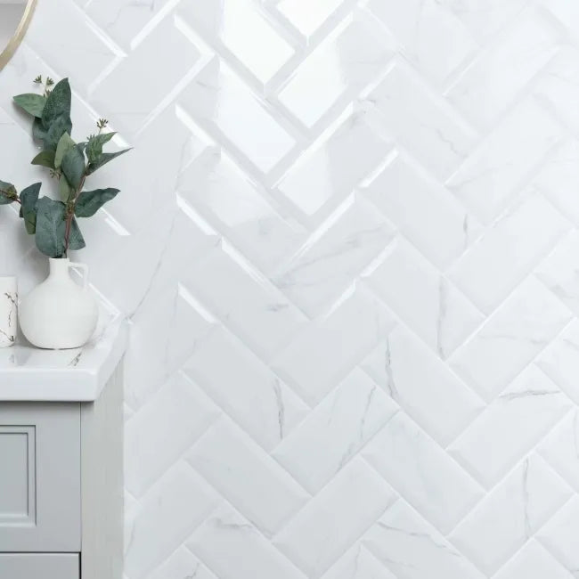White tiled wall with a marble subway geometric pattern in a bathroom setting