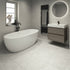 Modern bathroom with freestanding bathtub, sink, and mirror