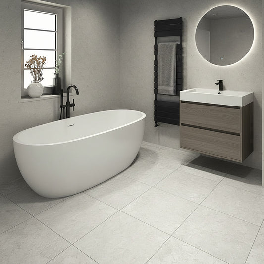 Modern bathroom with freestanding bathtub, sink, and mirror